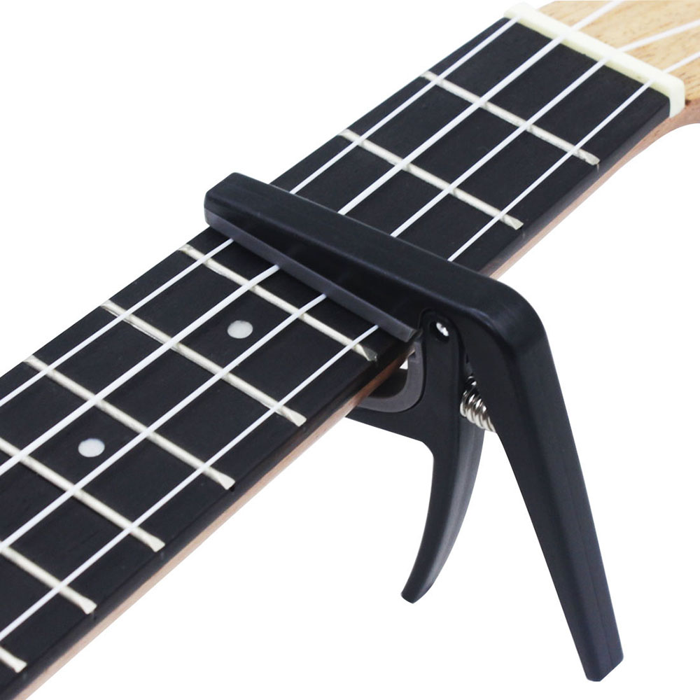 Musical Instrument Hawaii - Capo para Ukelele Profesional Negro, Abrazadera